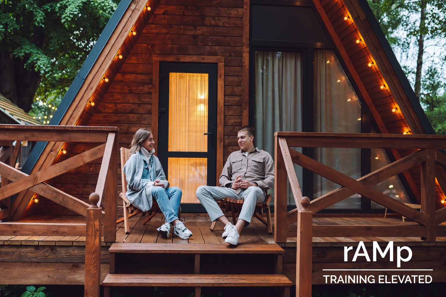 rAMp Training Elevated - Image of couple sitting in chairs on the posrch of an A-Frame home.